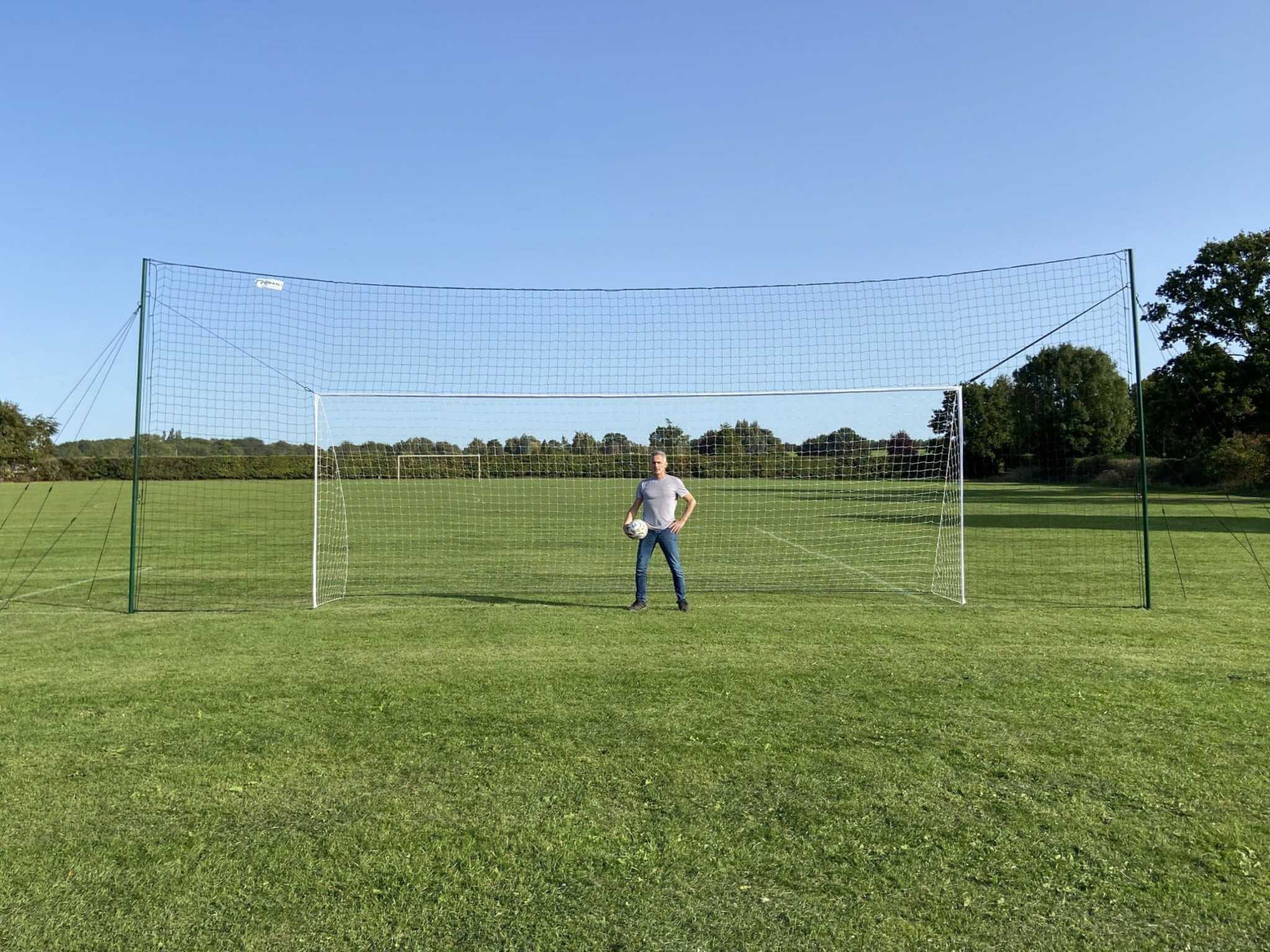 Player shooting into 24x8ft full size football goal with backstop