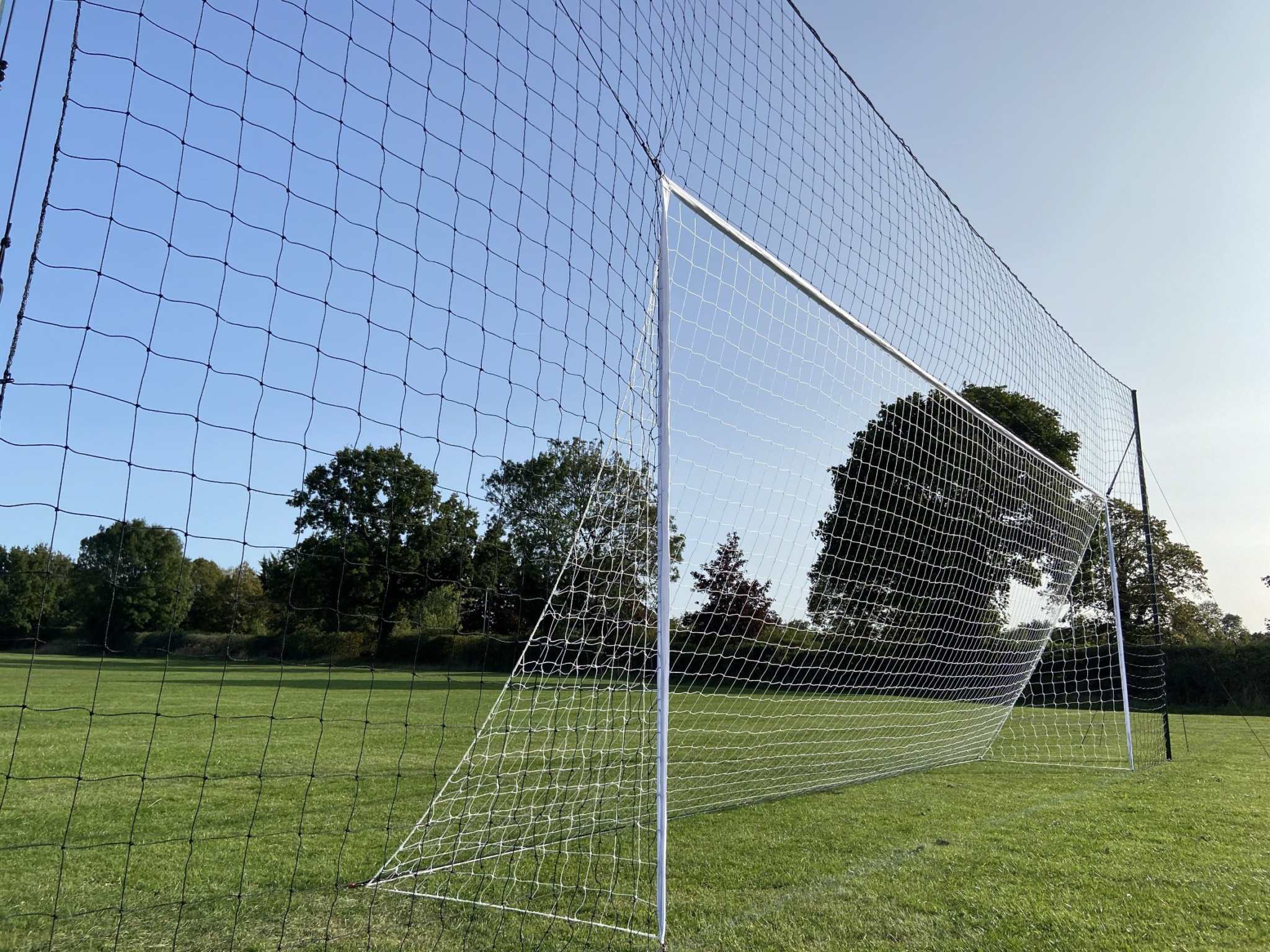 Front view of full size football goal for training with guy ropes