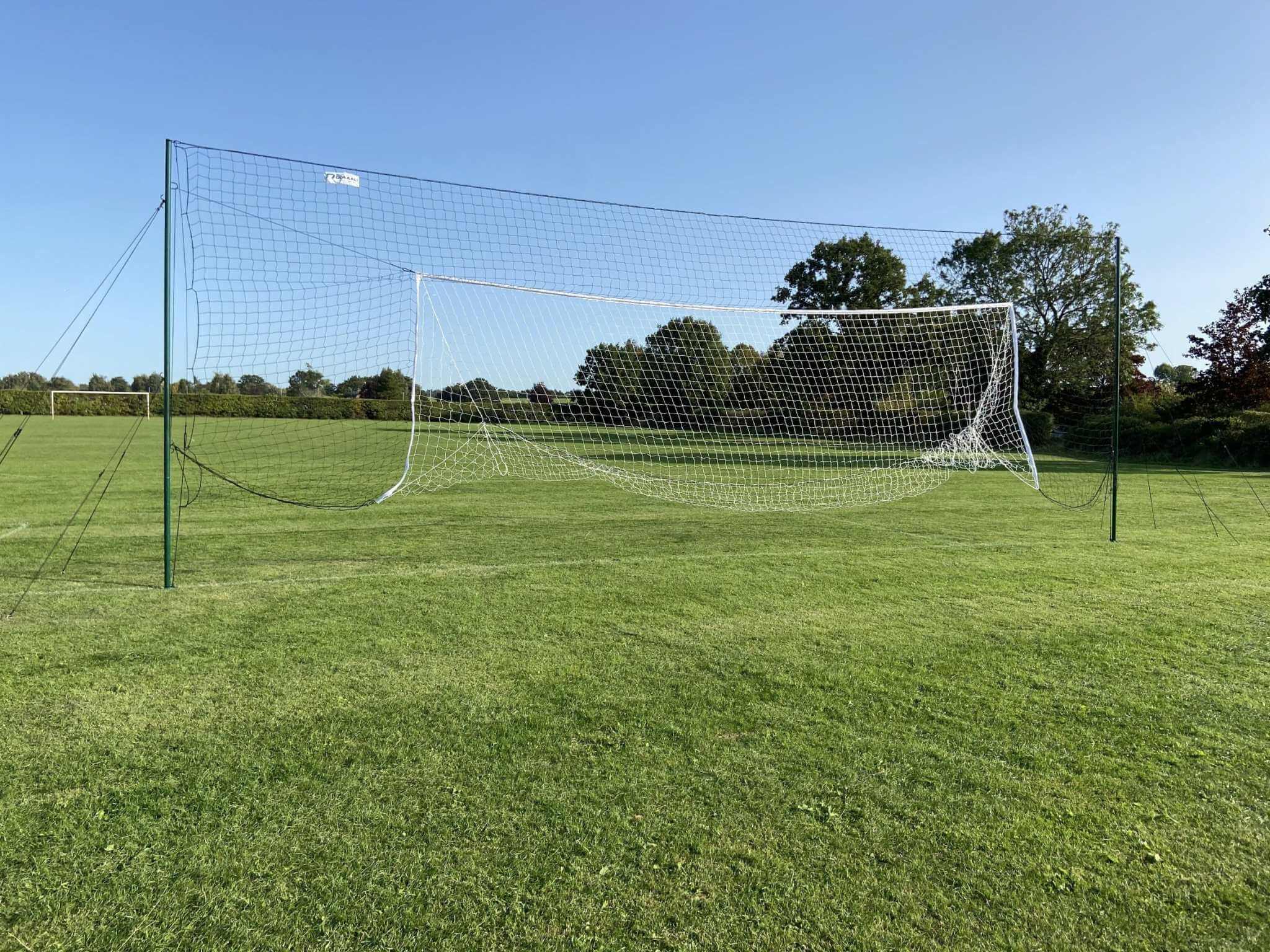 Back view of full size football goal with extended backstop net