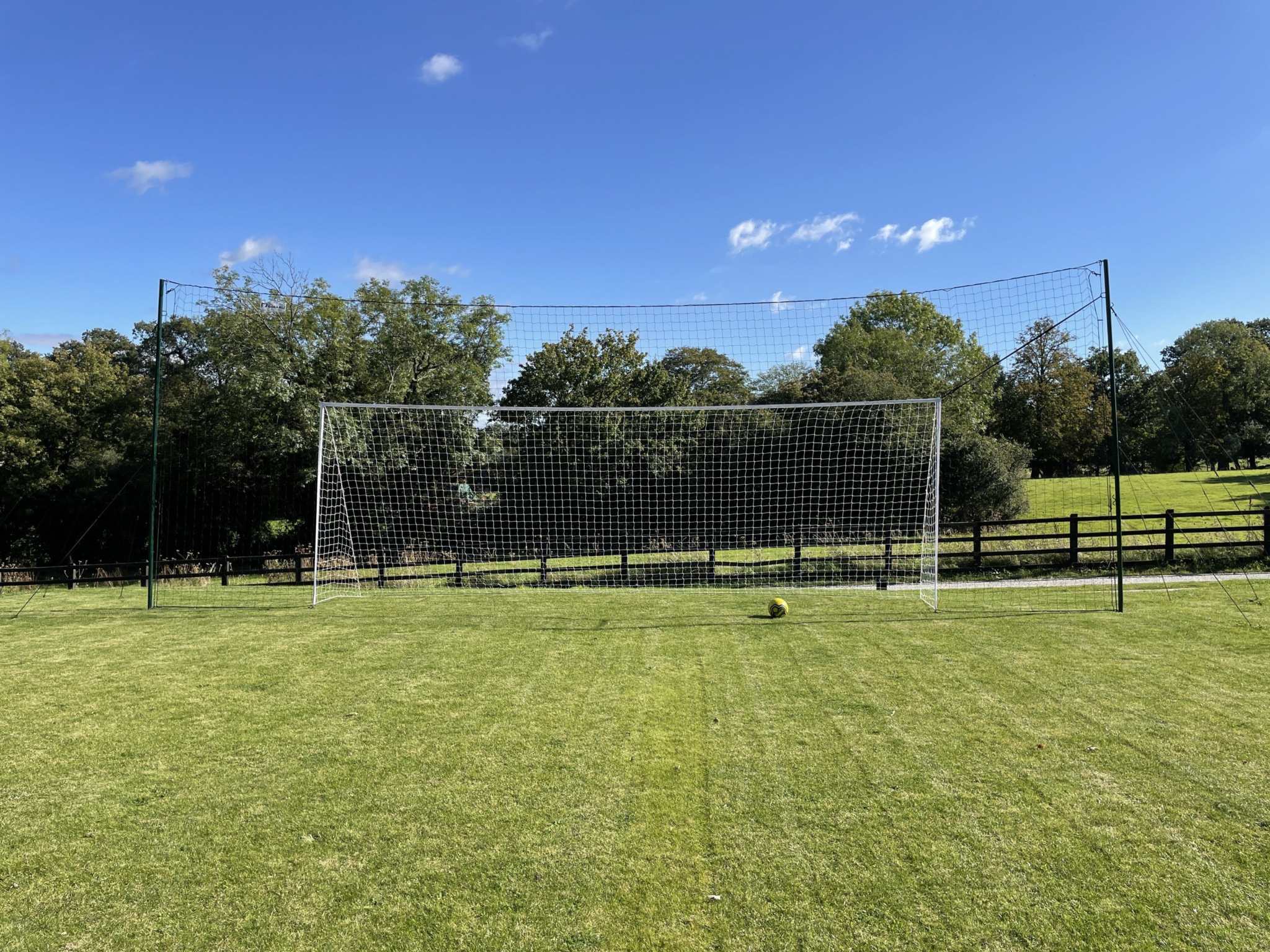 Side angle showing guy ropes extending from full size football goal
